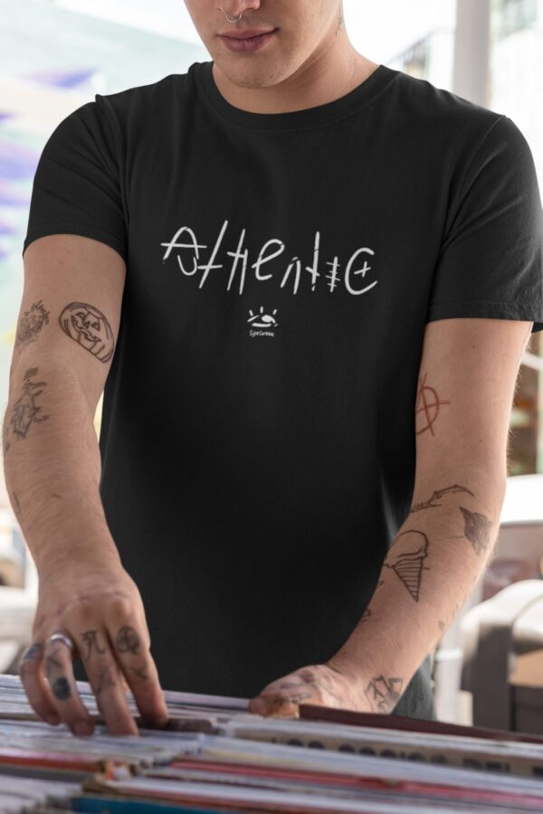 t shirt mockup featuring a man with tattooed arms at a music store 33313 1