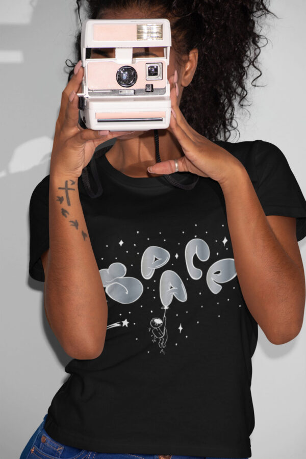 t shirt mockup featuring a woman taking a picture with a polaroid camera 21902