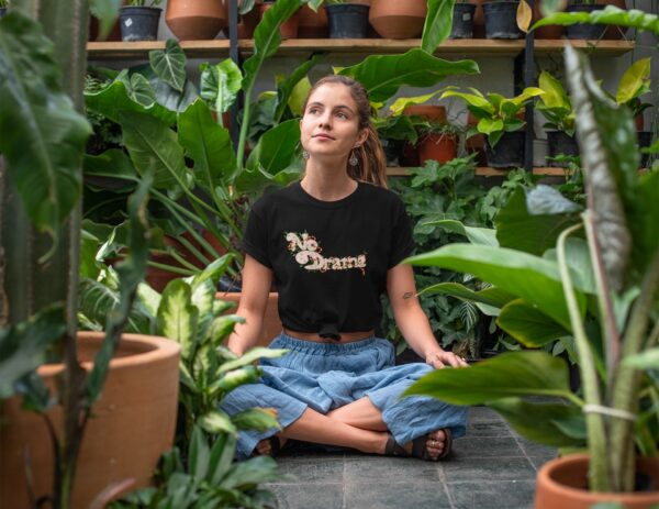 t shirt mockup of a relaxed young woman sitting in a greenhouse 27084